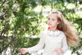 Kid dance to music in summer park. Small child enjoy music in headphones outdoor. Girl dancer with long flying hair Royalty Free Stock Photo