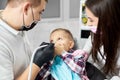 Kid in dental chair closes mouth with hands, fearing dentist Royalty Free Stock Photo