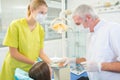 Kid in dental chair with dentist after repairing teeth Royalty Free Stock Photo