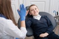 Kid in dental chair with dentist satisfied after repairing teeth giving five to doctor Royalty Free Stock Photo