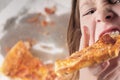 Kid devouring pizza