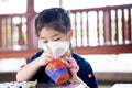 Kid doing art on plant pots made of terracotta clay. Royalty Free Stock Photo