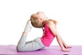 Kid doing fitness exercises on mat. Isolated on white. Royalty Free Stock Photo