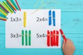 Kid doing multiplication equation using counting rods