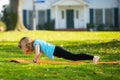 Kid doing pushing up on roll mat in park. Kids practicing push up outdoor. Child boy training. Royalty Free Stock Photo