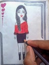 Kid drawing beautiful girl on notebook. colour pencil in hand
