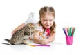 Kid drawing with pencils and playing with kitten Royalty Free Stock Photo