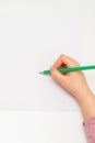 Kid is drawing on white blank paper Royalty Free Stock Photo