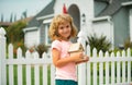 Kid dream of a new home. House concept. Child holding house in hands outdoors. Real estate and home insurance concept. Royalty Free Stock Photo