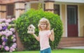 Kid dreaming of new home. Happy boy holding dream house in their hands, real estate and home insurance concept. Mortgage Royalty Free Stock Photo