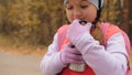 Kid drink water from an aluminum flask. One caucasian children rides bike road in autumn park. Little girl riding black Royalty Free Stock Photo