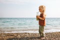 Kid drinking smoothie on sea beach child with glass bottle healthy lifestyle vegan food detox beverage Royalty Free Stock Photo