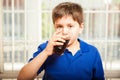 Kid drinking soda from a glass Royalty Free Stock Photo
