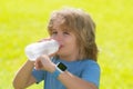 Kid drinking water. Portrait of happy smiling little child with glass of fresh water. Thirsty kid. Outdoor kid boy Royalty Free Stock Photo