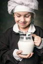 Kid drinks a glass of milk Royalty Free Stock Photo