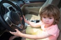 Kid Driver. Cute little boy pretending to drive. Kid in car with his hands on the wheel. Child Driver. Little kid Royalty Free Stock Photo