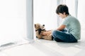 Kid with dyslexia sitting on floor