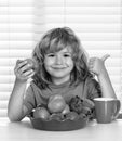 Kid eating apple. Portrait of child eat fresh healthy food in kitchen at home. Kid boy eating breakfast before school. Royalty Free Stock Photo