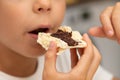 Kid eating bread with nut chocolate butter Royalty Free Stock Photo