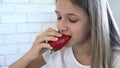 Kid Eating Breakfast in Kitchen, Girl Eats Vegetables, Hungry Blonde Child Enjoy Pepper, Healthy Food, Children Healthcare Royalty Free Stock Photo