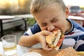 Kid eating burger Royalty Free Stock Photo