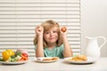 Kid eating egg. Portrait of child eat fresh healthy food in kitchen at home. Kid boy eating breakfast before school. Royalty Free Stock Photo