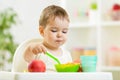 Kid eating healthy food on kitchen Royalty Free Stock Photo