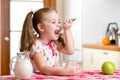 Kid eating healthy food in kitchen Royalty Free Stock Photo