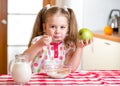 Kid eating healthy food in kitchen Royalty Free Stock Photo