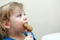 Kid eating sausage