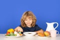 Kid eating soup. Children eat breakfast. Cute child eating lunch soup. Closeup face of kid eating organic food, yogurt Royalty Free Stock Photo