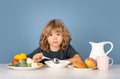 Kid eating soup. Healthy breakfast for kids. Child having lunch and eating soup. Closeup face of kid eating organic food Royalty Free Stock Photo