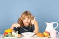 Kid eating soup. Hungry face and enjoy eating enjoy food concept. Funny kid with plate of soup. Royalty Free Stock Photo