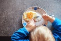 Kid eats fried egg with fork