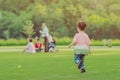 Kid enjoy to playing with little ball on field