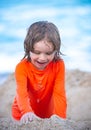 Kid enjoying time at the sand beach. Child making sandcastle on sea. Royalty Free Stock Photo