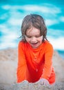 Kid enjoying time at the sand beach. Child making sandcastle on sea. Royalty Free Stock Photo