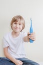 Kid exhibits his electric toothbrush Royalty Free Stock Photo