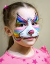Kid with face painting of kitty, portrait of pretty child with beautiful makeup