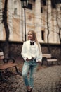 Kid fashion trend and style. Girl smile in fashionable jeans in park, fashion. Little child with long blond hair outdoor