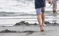 Kid feet running on a sand beach Royalty Free Stock Photo