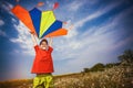 Kid flies a kite into the blue sky Royalty Free Stock Photo