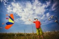 Kid flies a kite into the blue sky Royalty Free Stock Photo