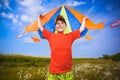 Kid flies a kite into the blue sky Royalty Free Stock Photo