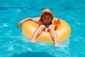 Kid floating in pool. Child relaxing in pool, drink summer cocktail. Kids summer vacation. Children floating in water Royalty Free Stock Photo