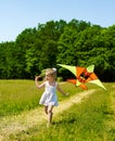 Kid flying kite outdoor. Royalty Free Stock Photo