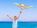 Kid flying kite outdoor. Royalty Free Stock Photo