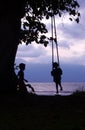 Kid & Friend on Swing Borneo Coast Royalty Free Stock Photo