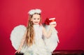 Kid girl angel with present gift, studio portrait. Little angel with white wings holds gift, happy fairy. Cute angel Royalty Free Stock Photo