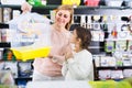 Kid girl begging her mother to buy bird cage Royalty Free Stock Photo